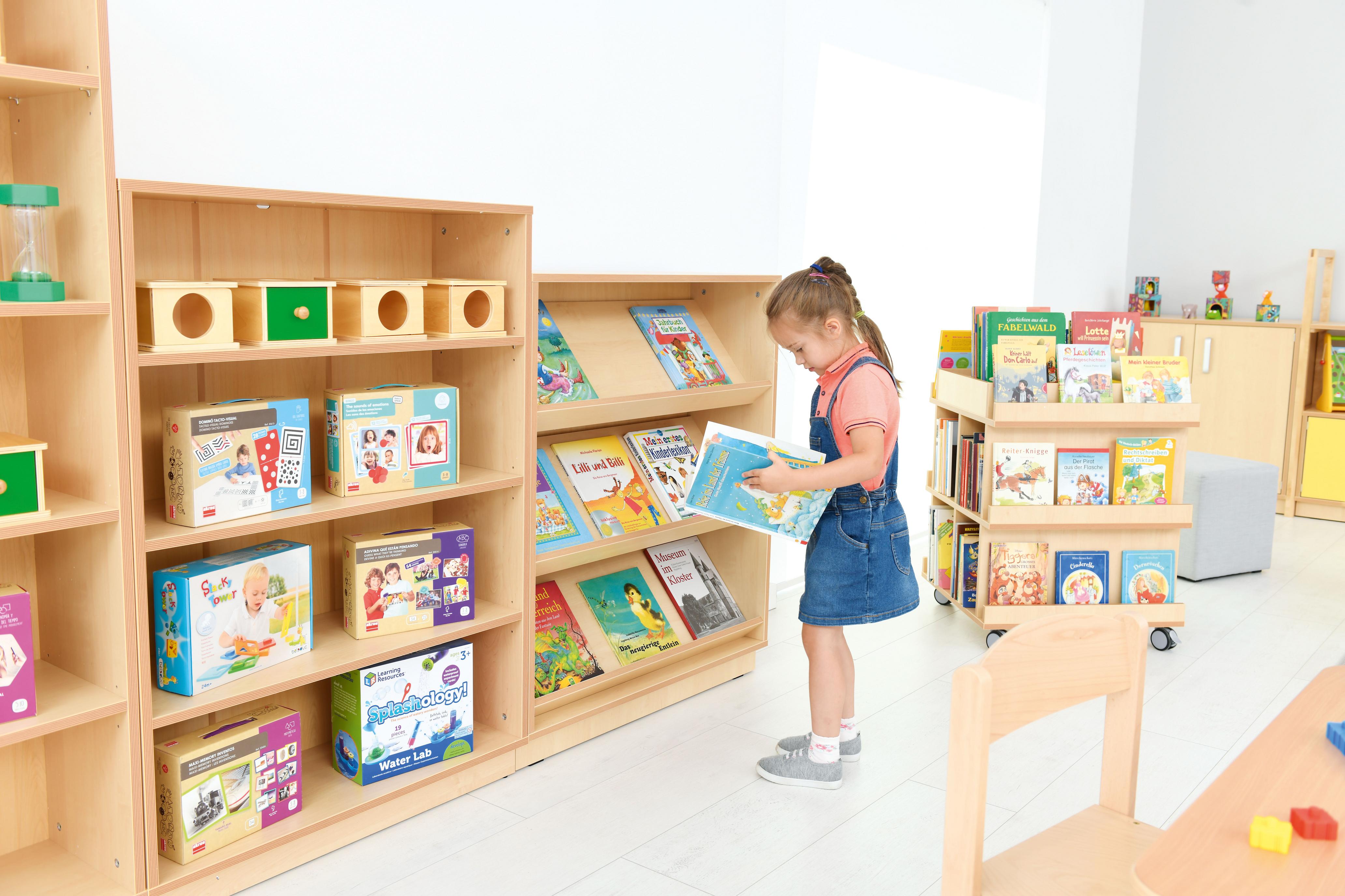 Bücherauslage in Kita-Raum mit Kind beim Lesen. - Produkt wird im Kindergarten oder Schule genutzt.